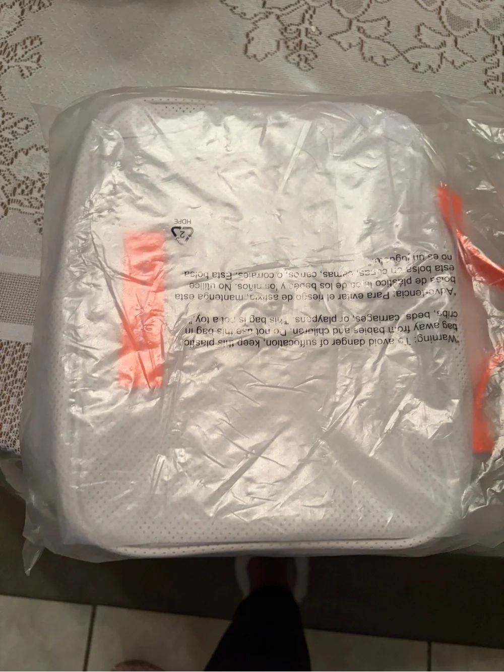 Drunk Elephant white and neon orange bag.